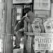 Man outside a liquor store in Oakland, California, 1962